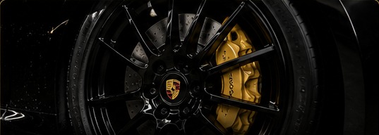 Premium black alloy wheel with a gold performance brake caliper